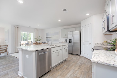 kitchen with vinyl floors an island and stainless steel appliances