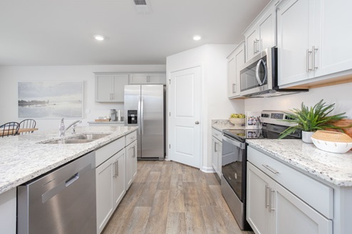 kitchen with vinyl floors an island and stainless steel appliances