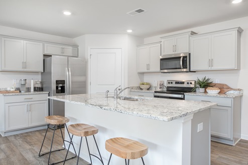 kitchen with vinyl floors an island and stainless steel appliances