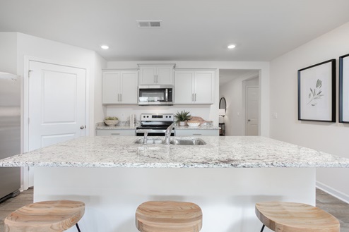 kitchen with vinyl floors an island and stainless steel appliances