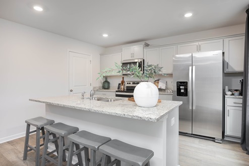 kitchen with vinyl floors an island and stainless steel appliances