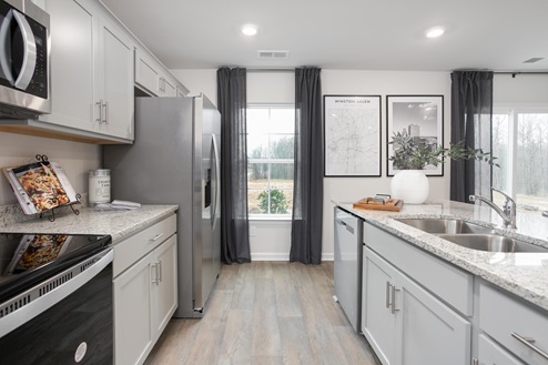 kitchen with vinyl floors an island and stainless steel appliances