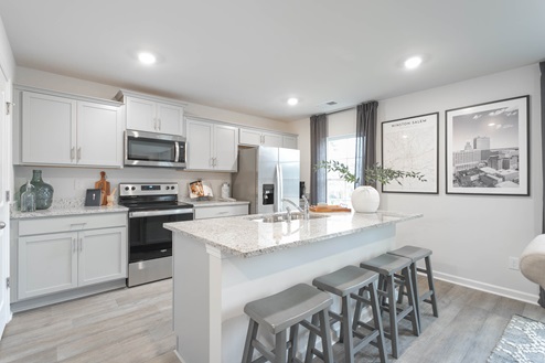 kitchen with vinyl floors an island and stainless steel appliances