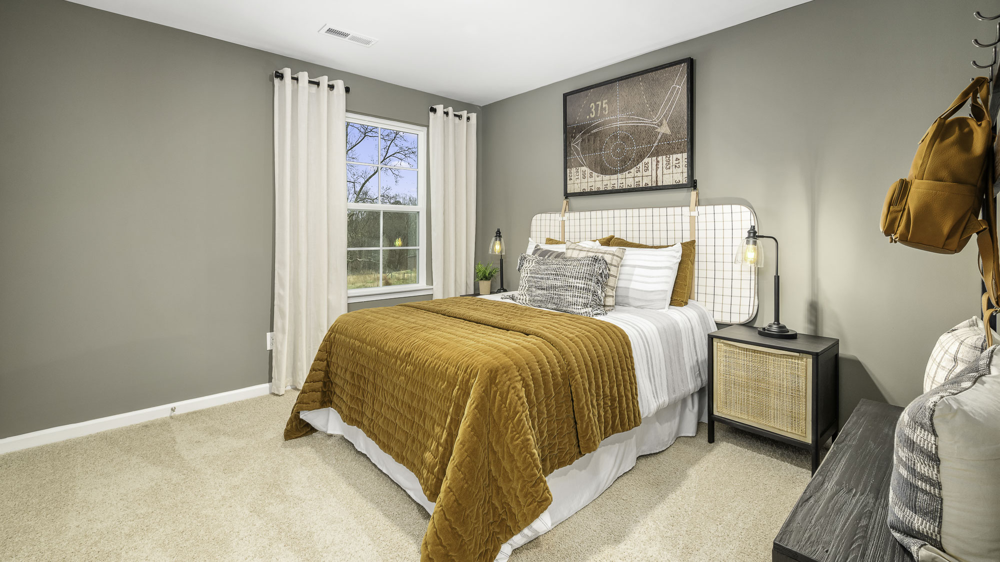 secondary bedroom with window and carpet