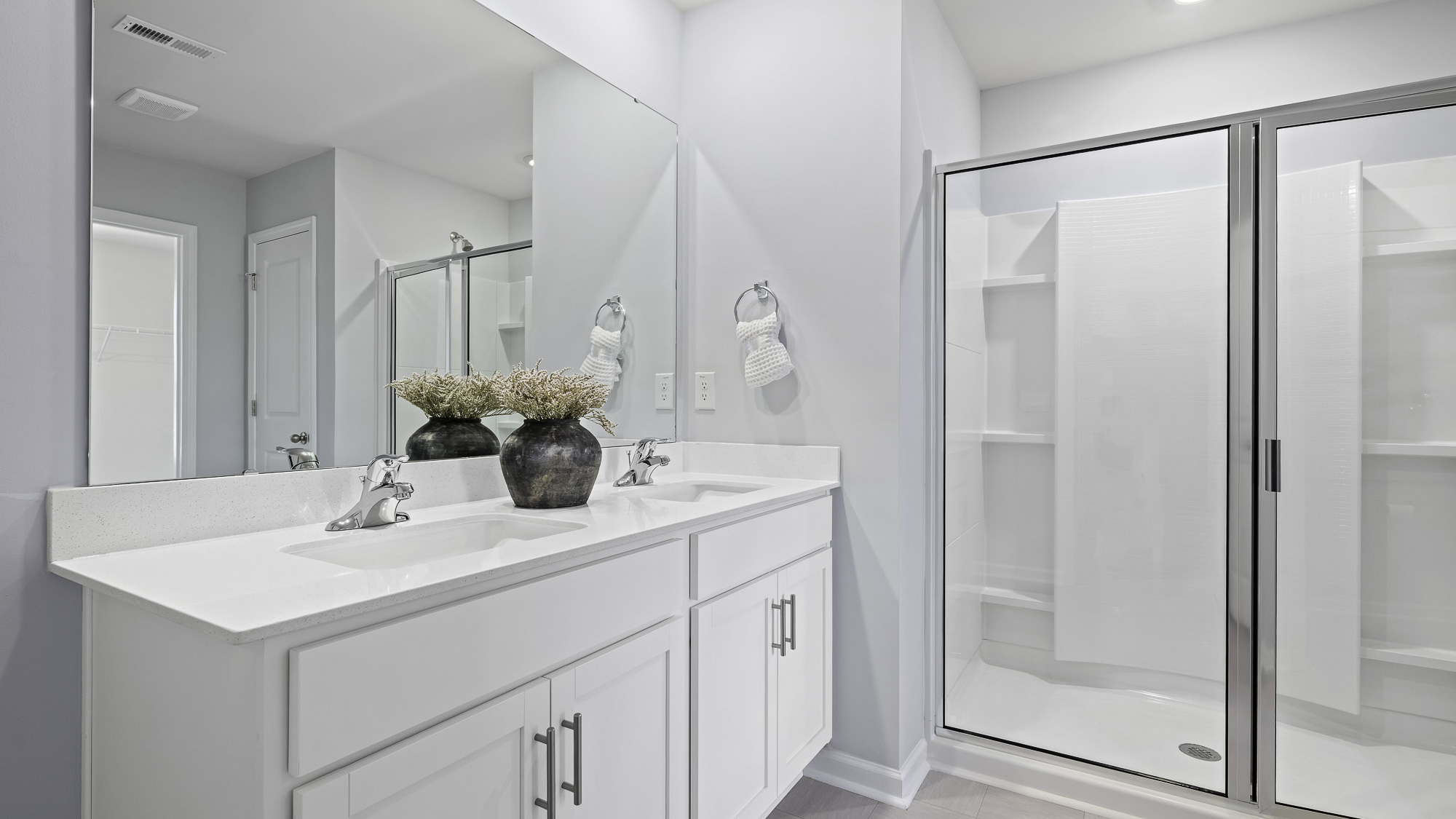 main bathroom with dual sink and walk-in shower