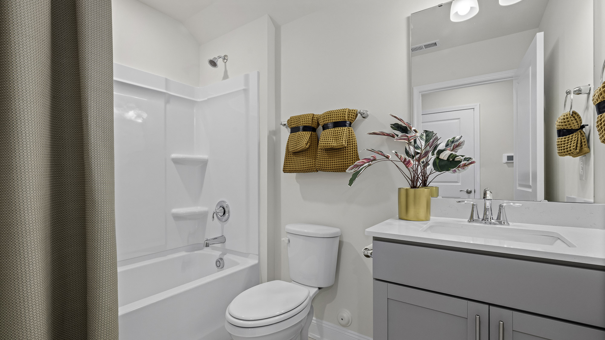 bathroom three with tub shower combo