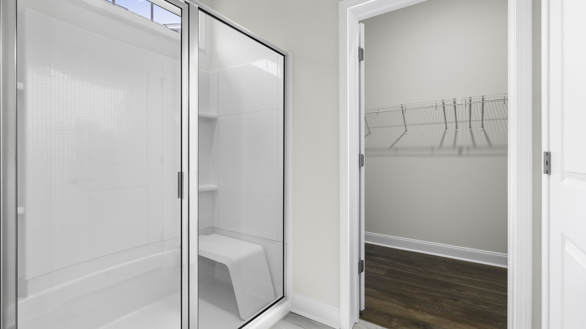 main bathroom with walk-in shower and walk in closet