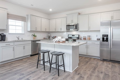 kitchen with revwood floors an island and stainless steel appliances