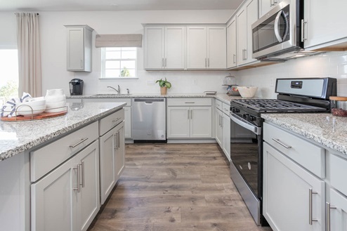 kitchen with revwood floors an island and stainless steel appliances