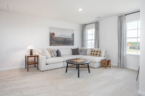 Loft with carpet and natural light