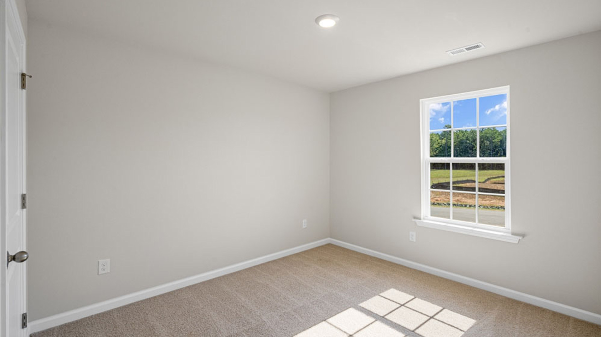 bedroom with carpet and natural light