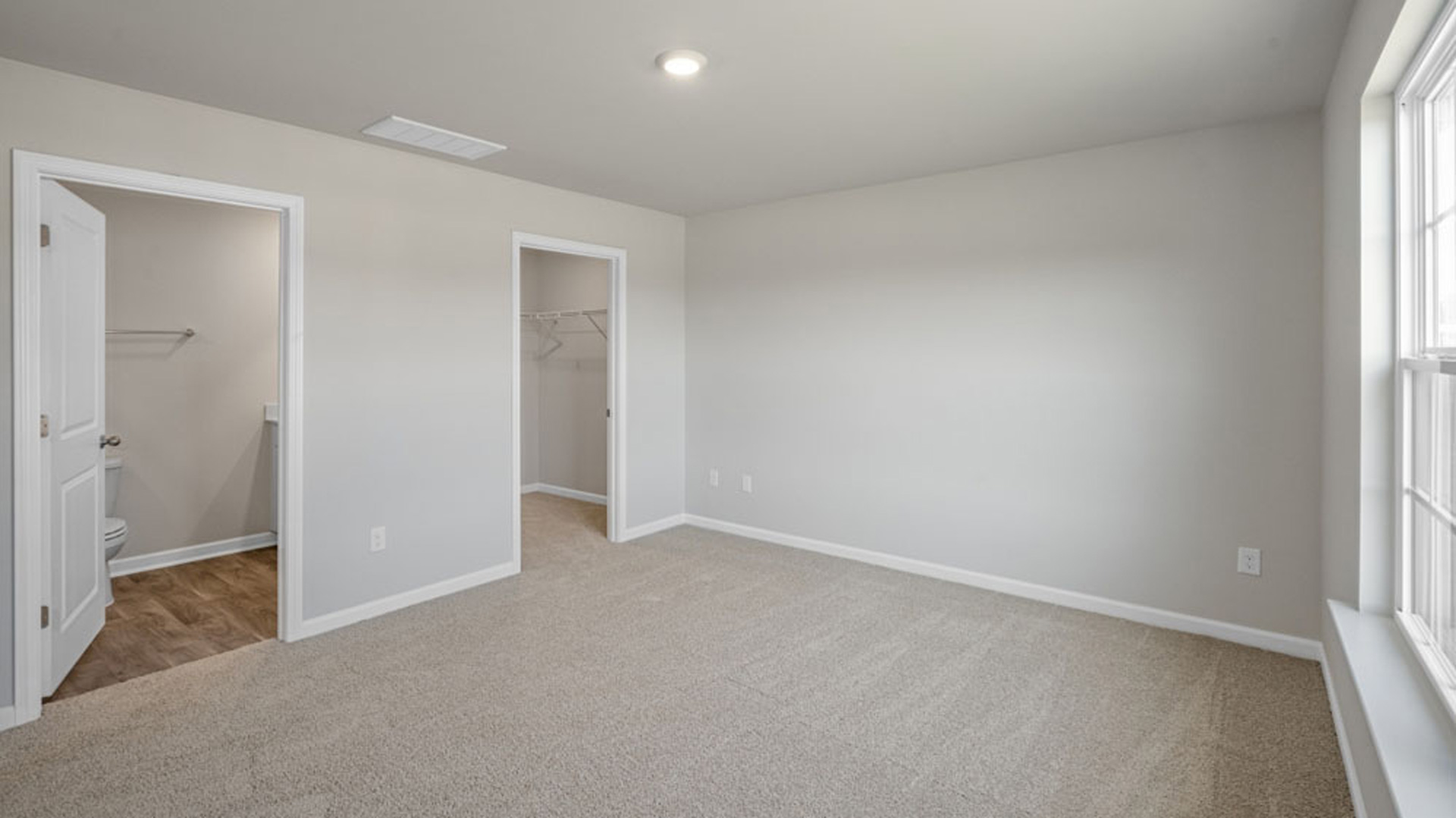 bedroom with carpet and natural light