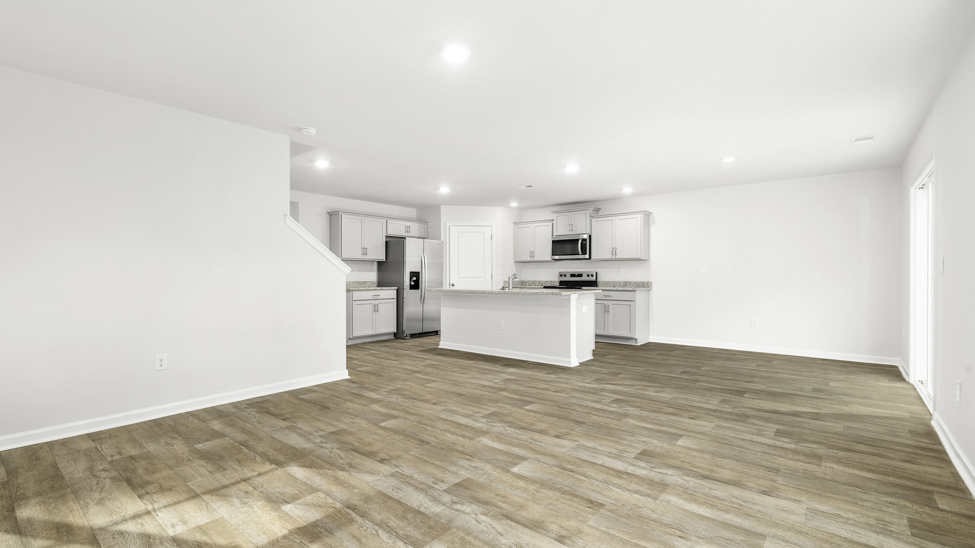 LIVING ROOM AND PARTIAL KITCHEN