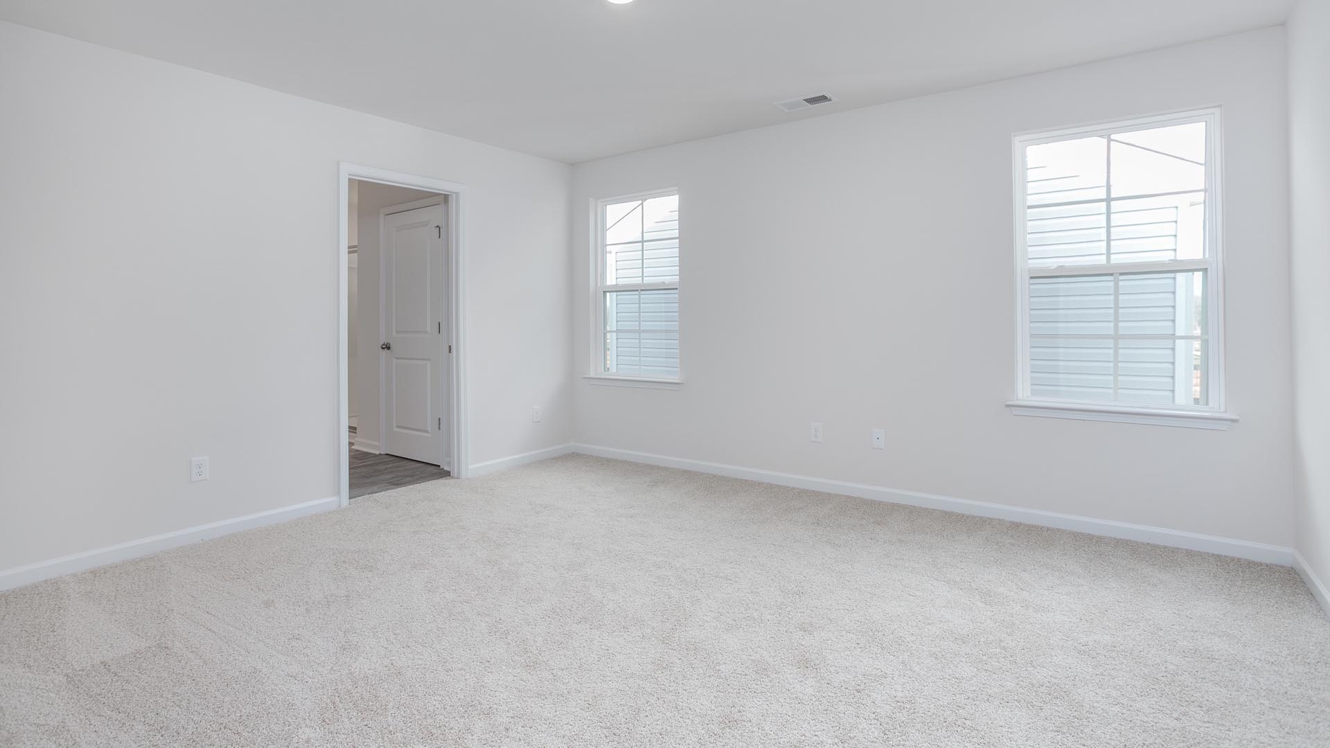 bedroom with carpet and natural light