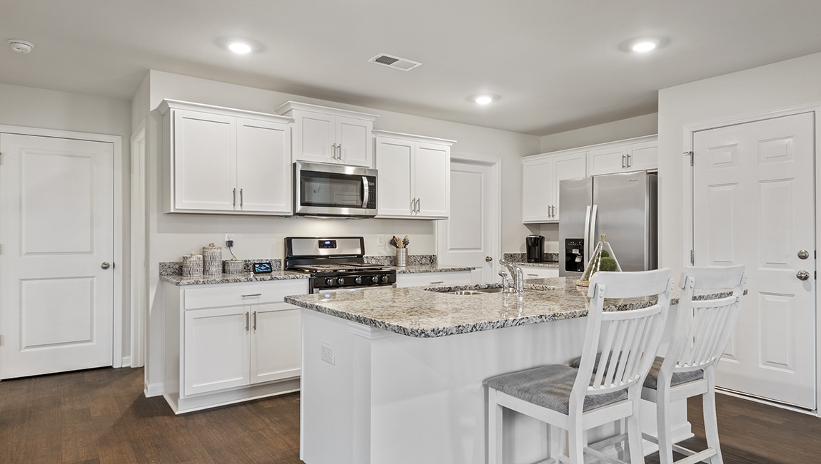 kitchen with island, vinyl floor, and stainless steel appliances
