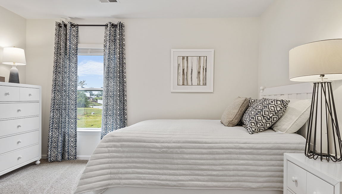 Bedroom with carpet and natural light