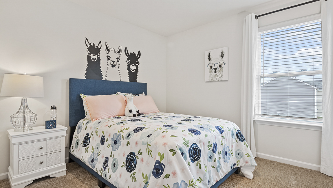 Bedroom with carpet and natural light