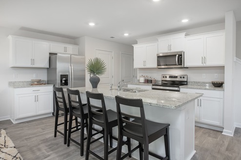 kitchen with vinyl floors an island and stainless steel appliances