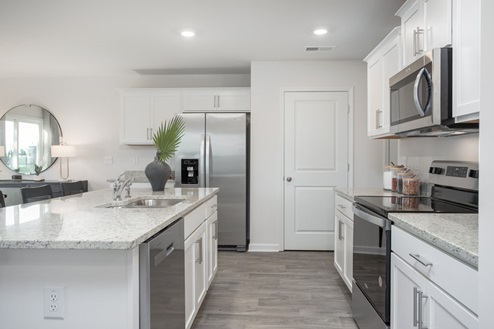 kitchen with vinyl floors an island and stainless steel appliances