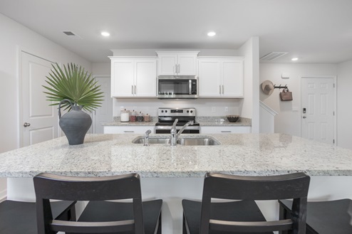 kitchen with vinyl floors an island and stainless steel appliances