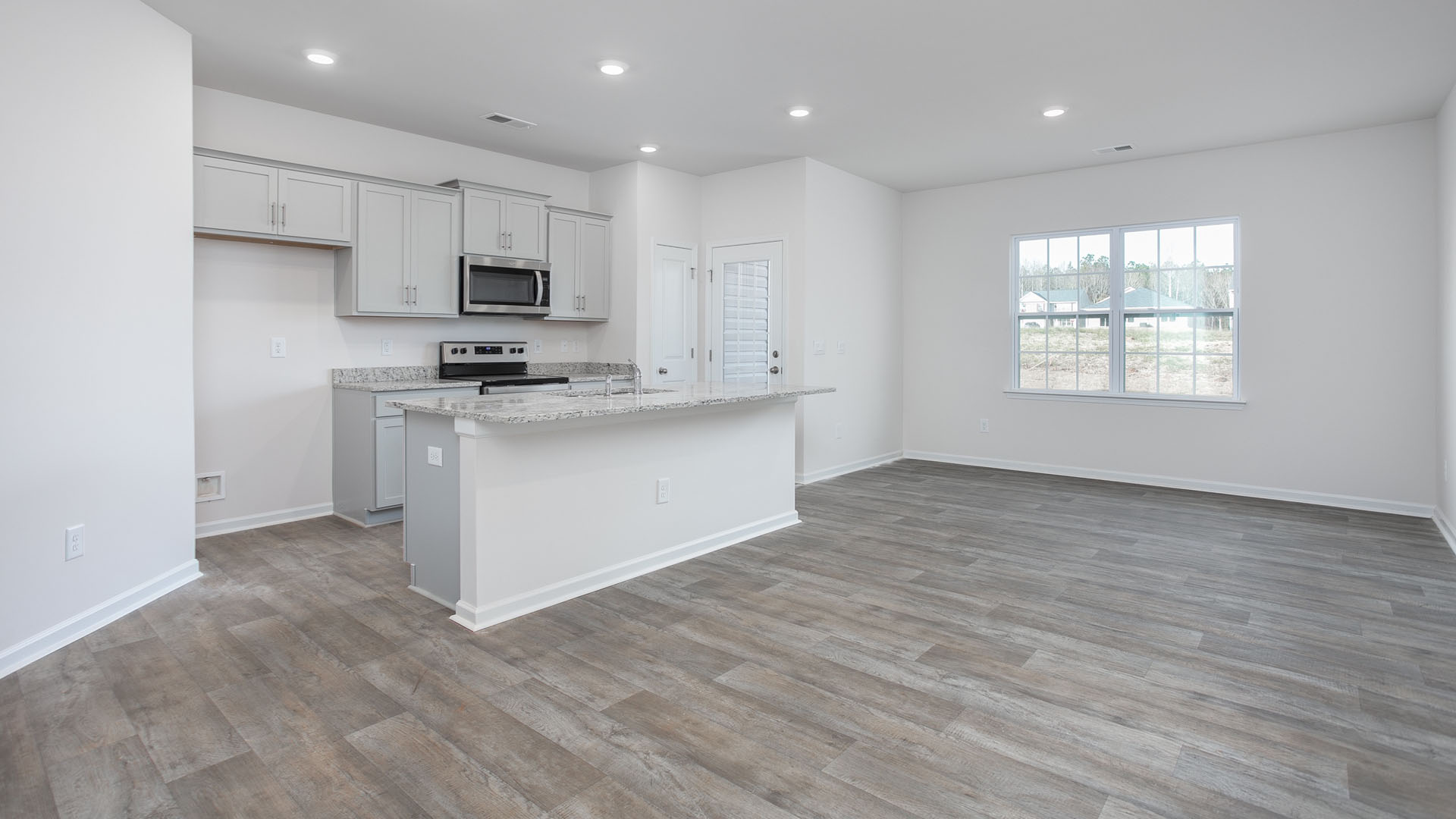 Kitchen with island and vinyl floor