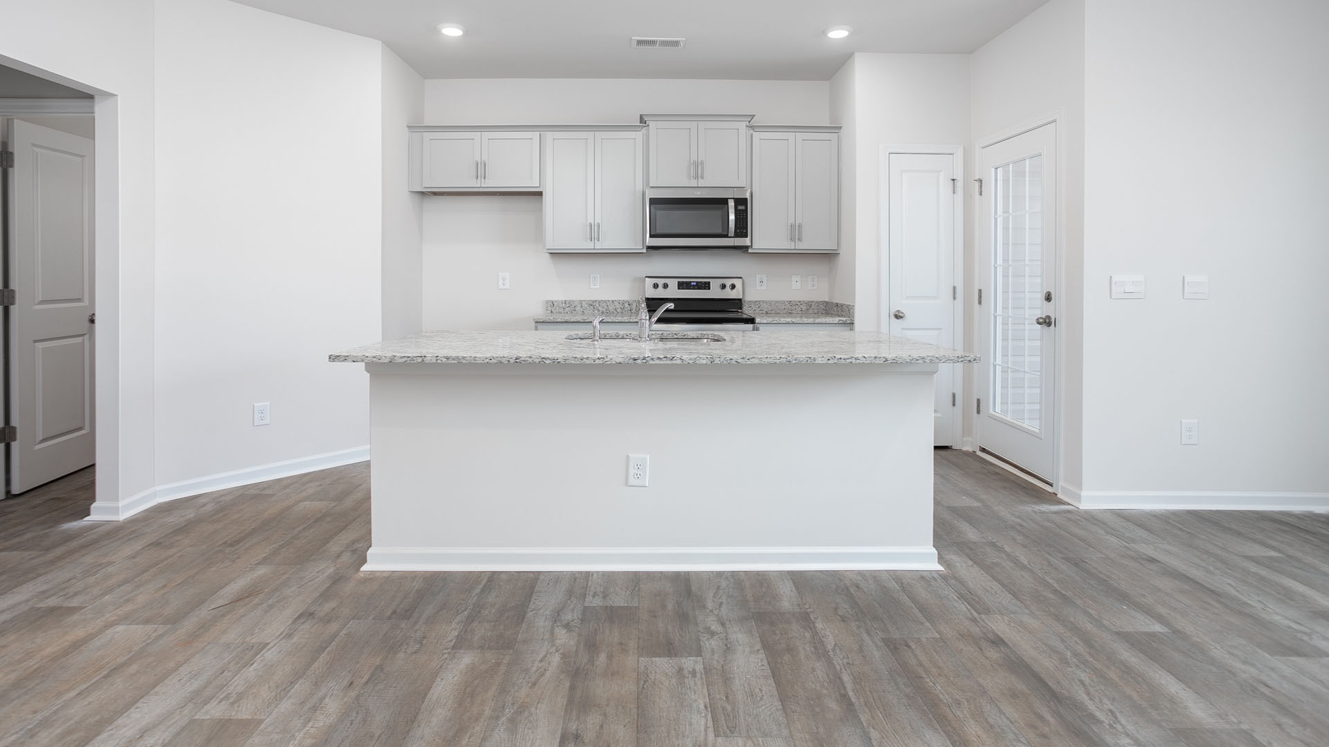 Kitchen with island and vinyl floor