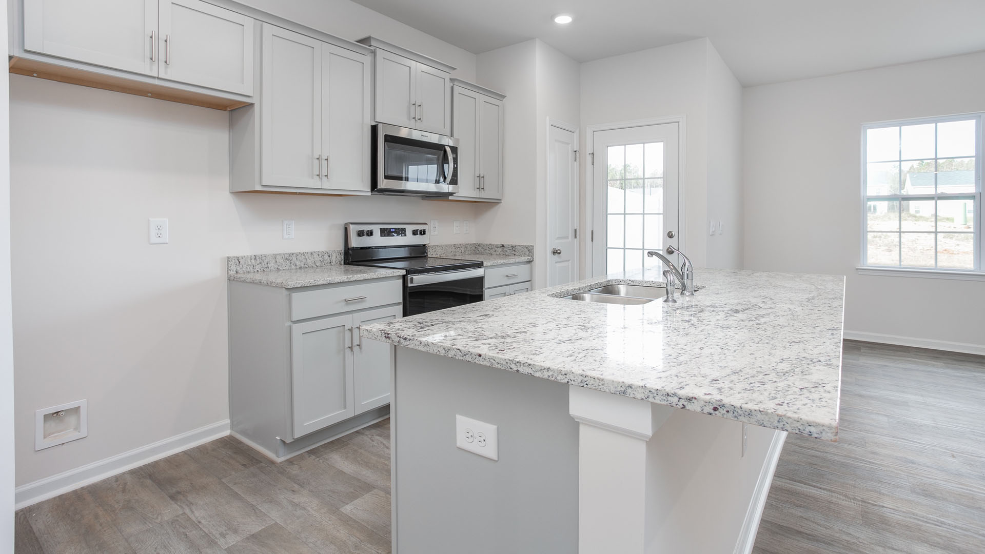 Kitchen with island and vinyl floor