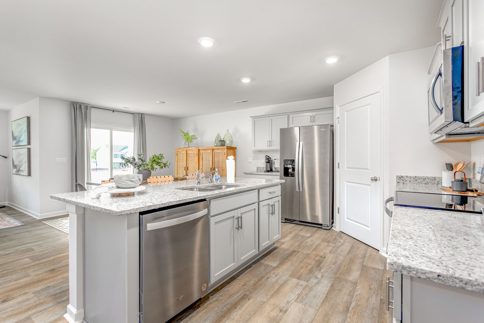 kitchen with island, vinyl floor and stainless steel appliances