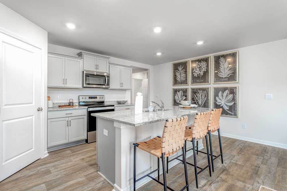 kitchen with island, vinyl floor and stainless steel appliances