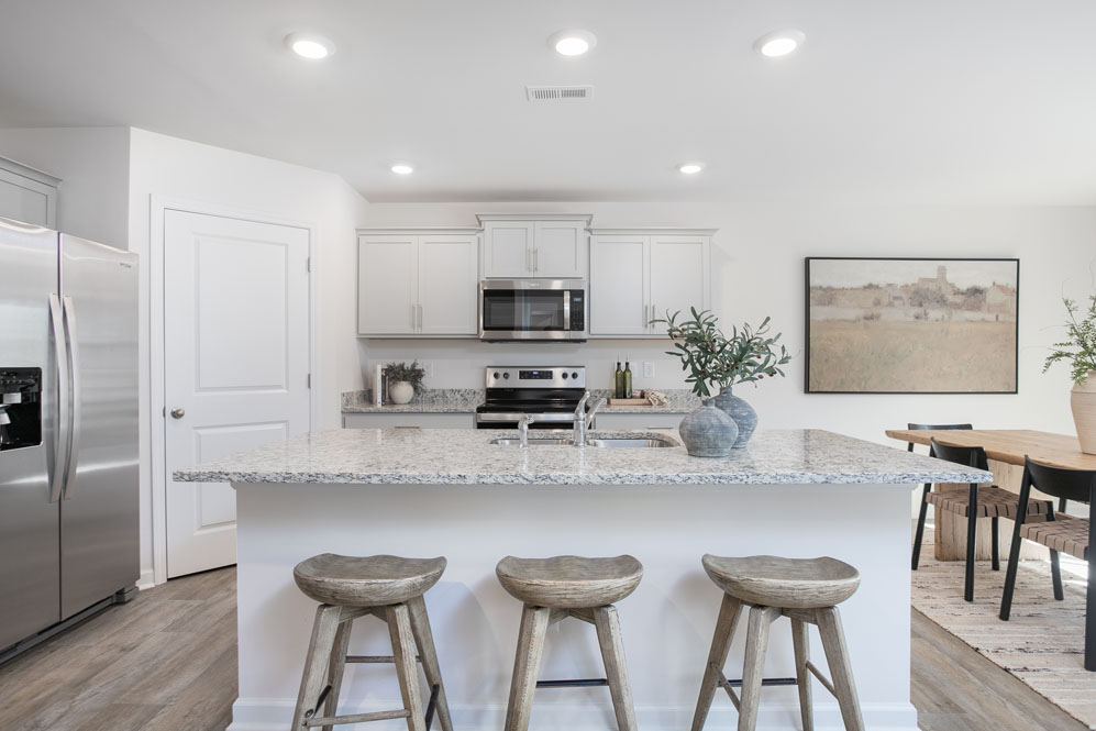kitchen with island, vinyl floor and stainless steel appliances