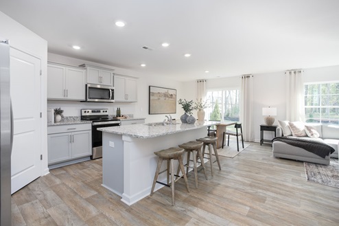 kitchen with vinyl floors an island and stainless steel appliances
