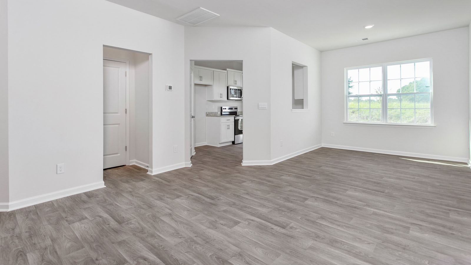 Interior space featuring wood-finish flooring, recessed lighting, and a multi-pane window