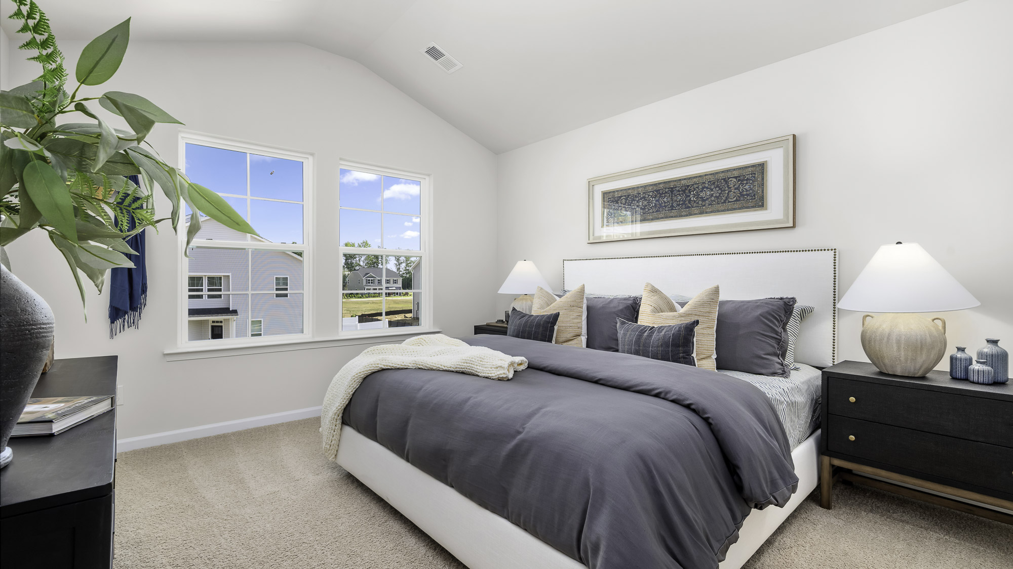 primary bedroom with a vaulted cieling