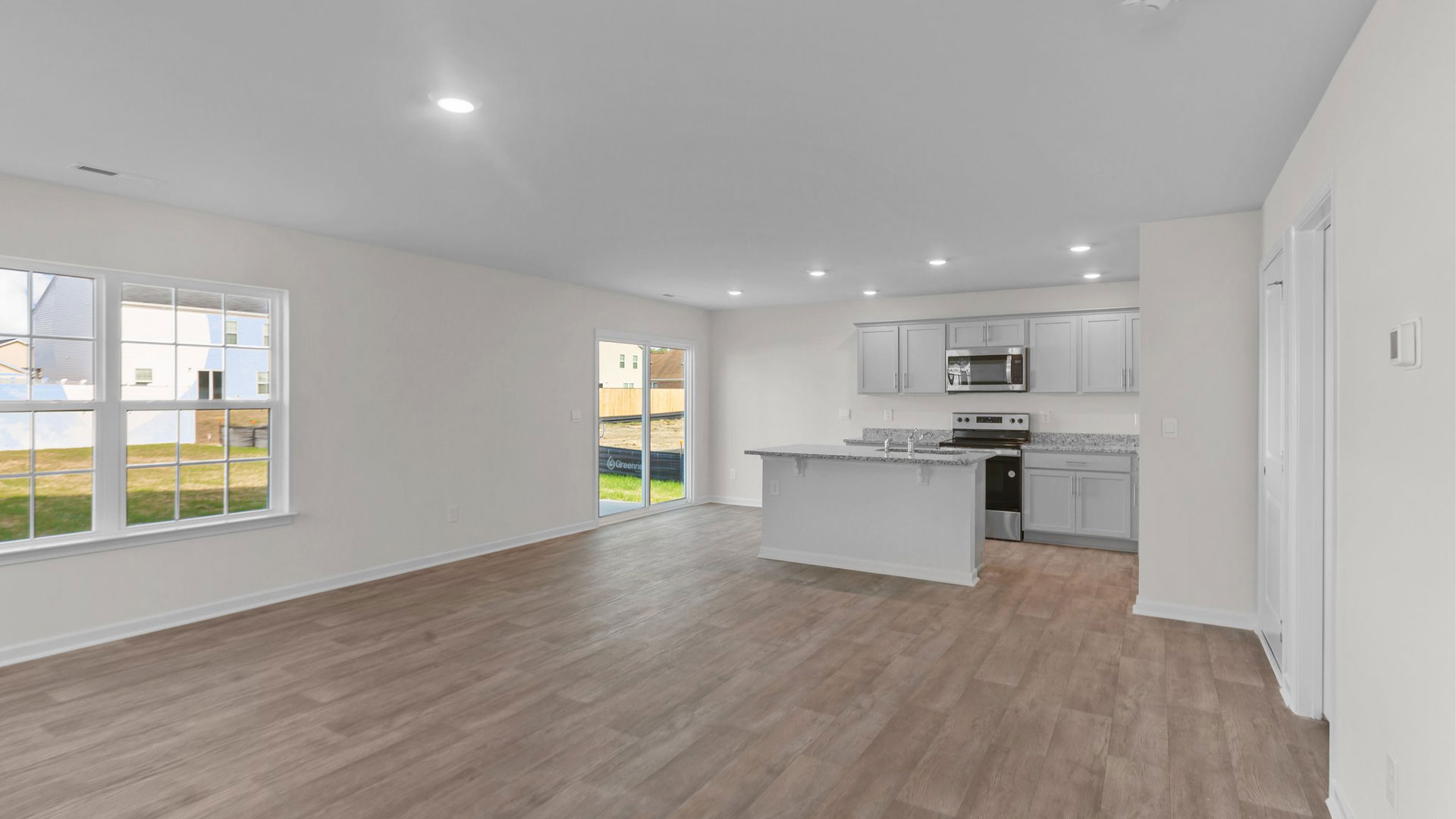 living room with vinyl floor and natural light