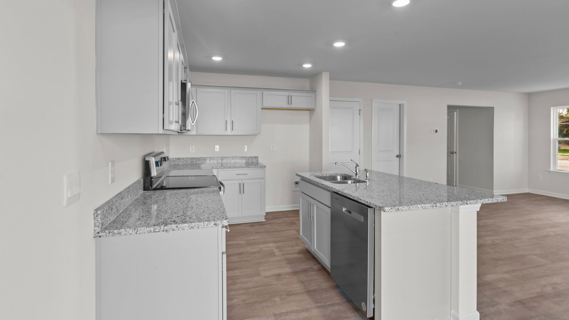 kitchen with island, vinyl floors, and stainless steel appliances