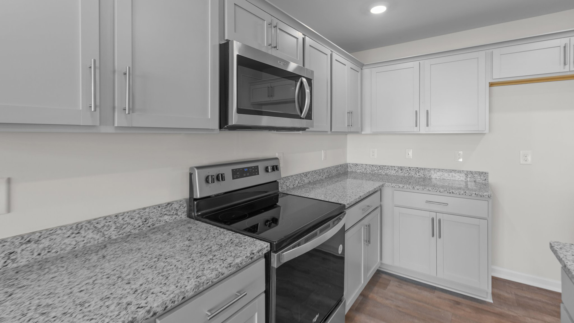 kitchen with island, vinyl floors, and stainless steel appliances