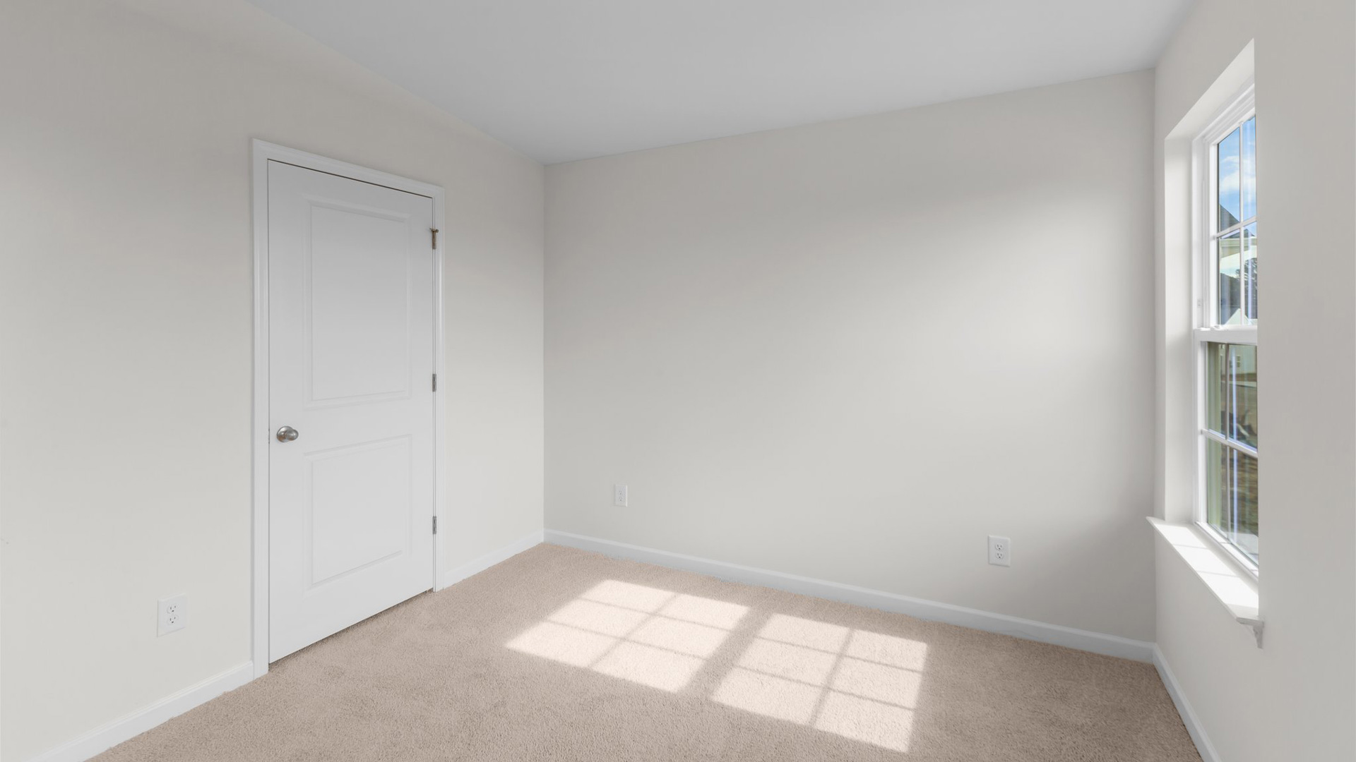 Bedroom with carpet and natural light