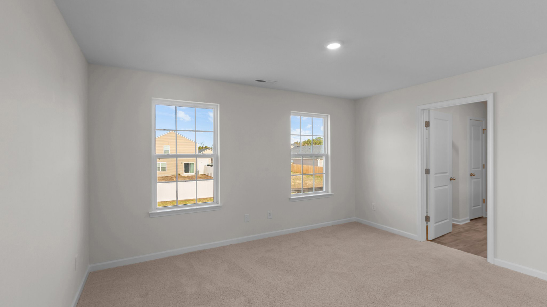 Bedroom with carpet and natural light