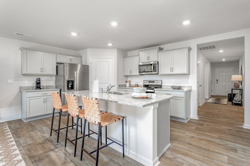 kitchen with vinyl floors an island and stainless steel appliances