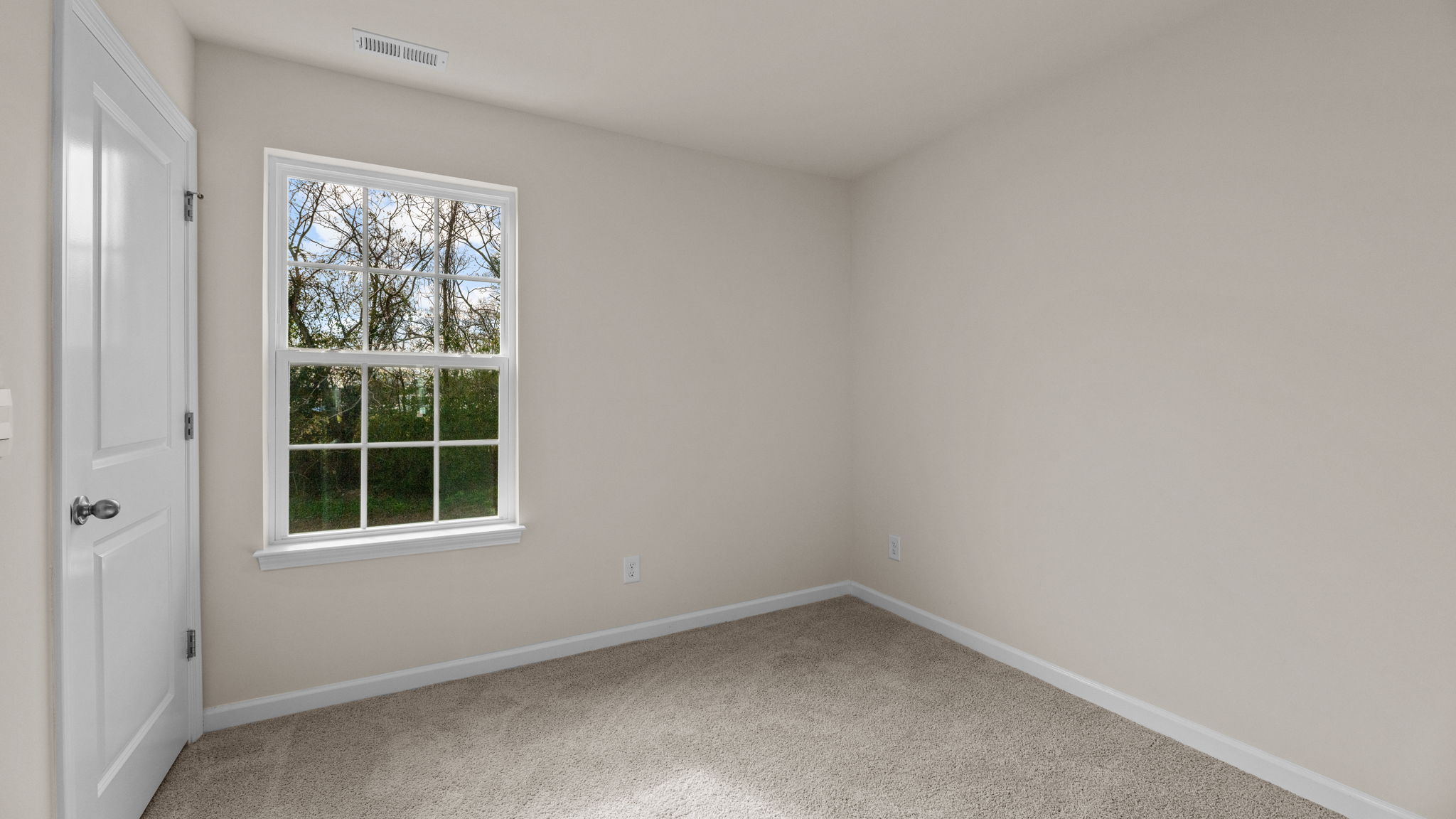 bedroom with carpet and natural light