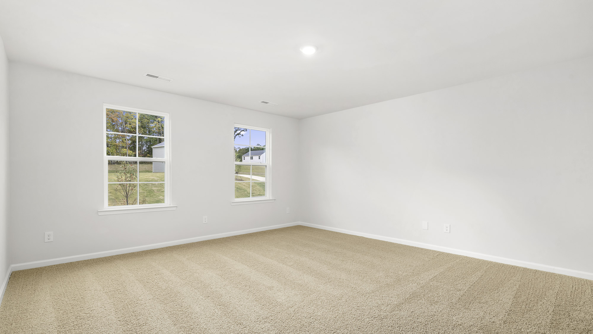 bedroom with carpet and 2 windows