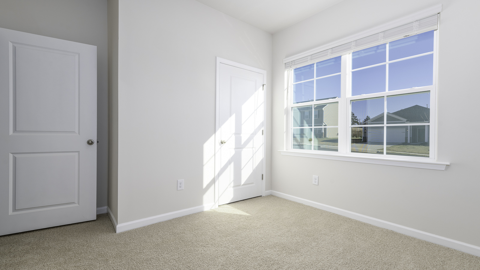 secondary bedroom with closet and carpet