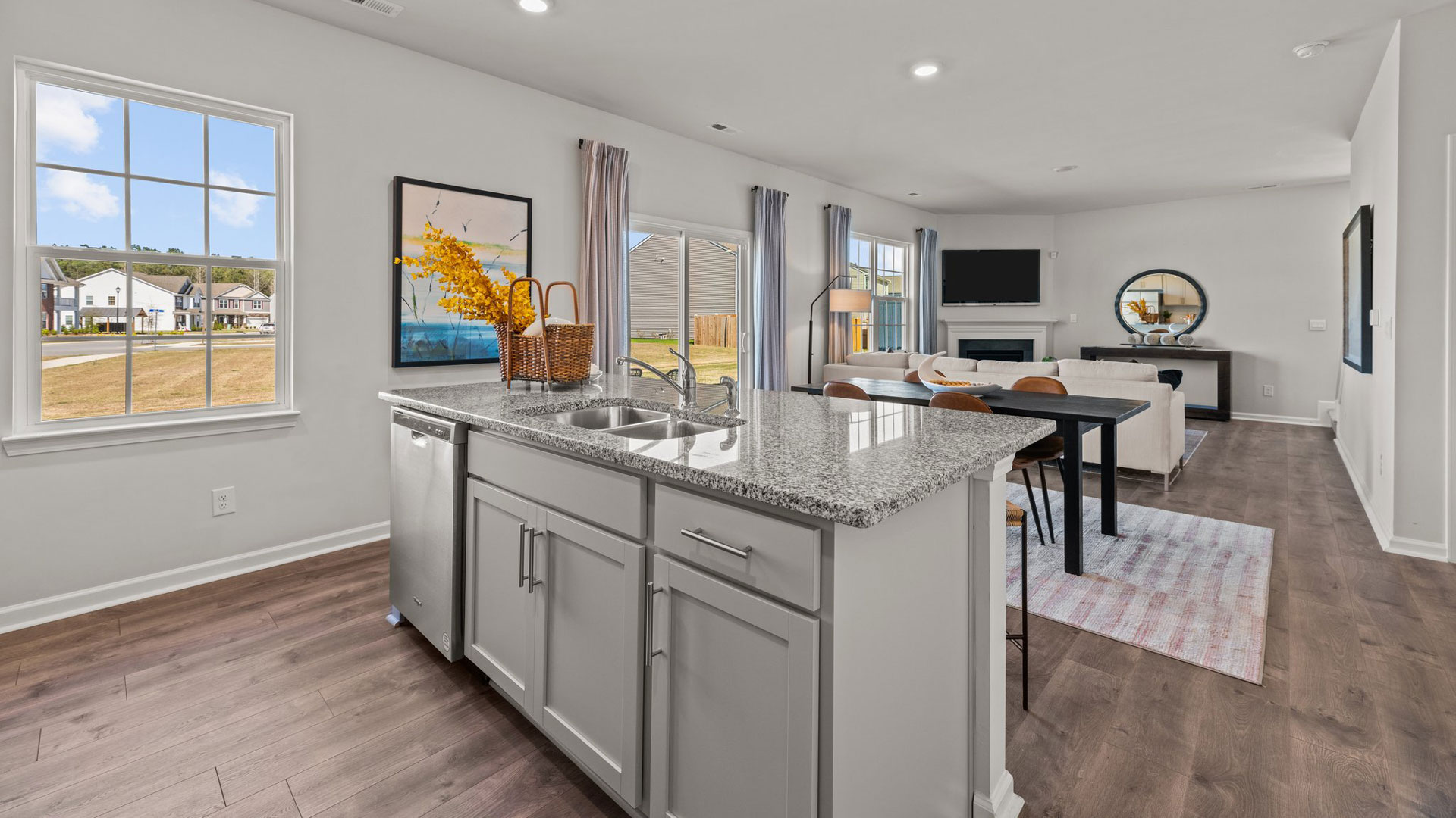kitchen with revood flooors, island and stainless steel appliances