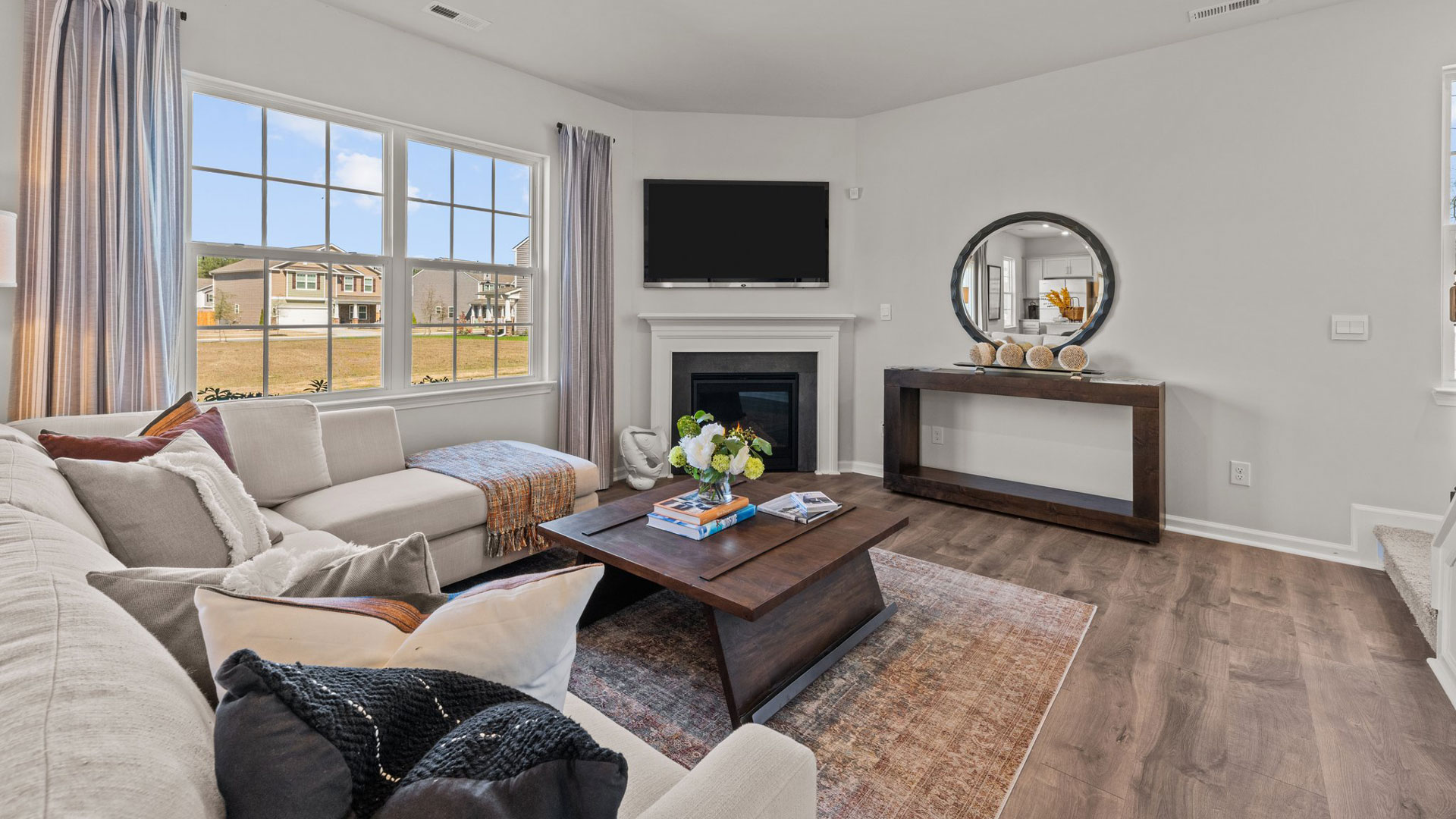 living room with revwood floor and natural light
