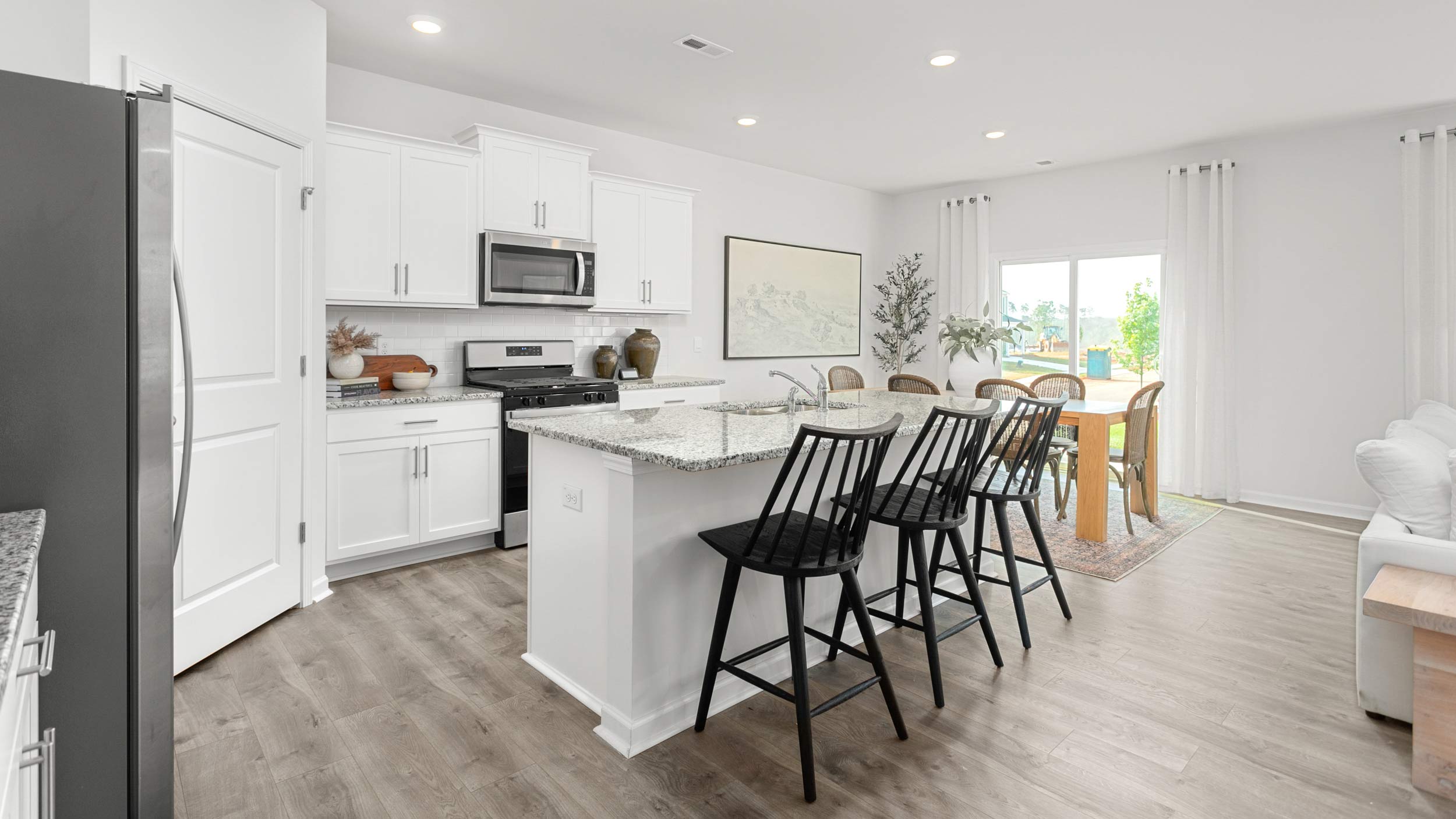 kitchen with revwood floors, an island, and stainless steel appliances