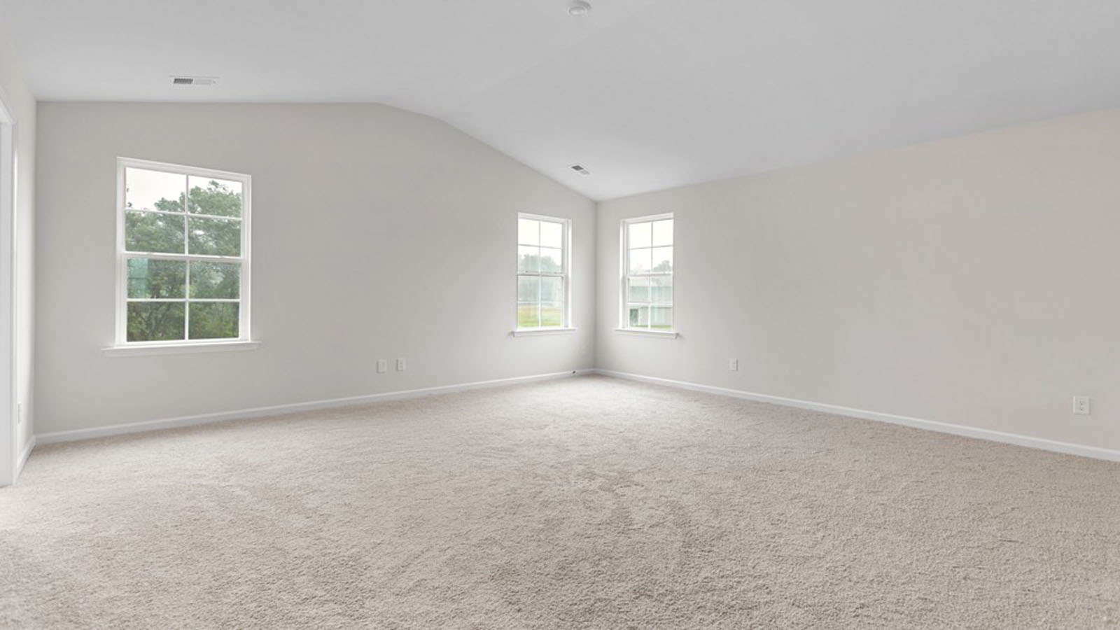 primary bedroom with vaulted cielings