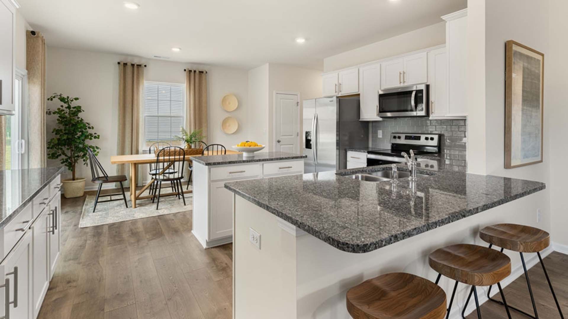 kitchen with island and revwood floor, with stainless steel appliances