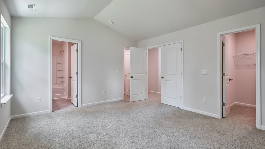 primary bedroom with vaulted ceilings