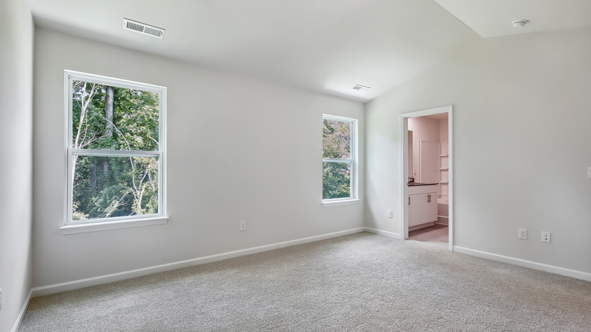 primary bedroom with vaulted cielings