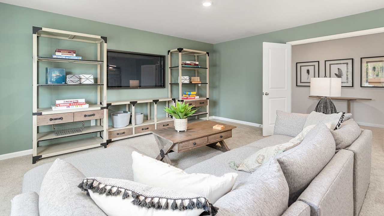Living area featuring neutral carpeting and sage green wall paint